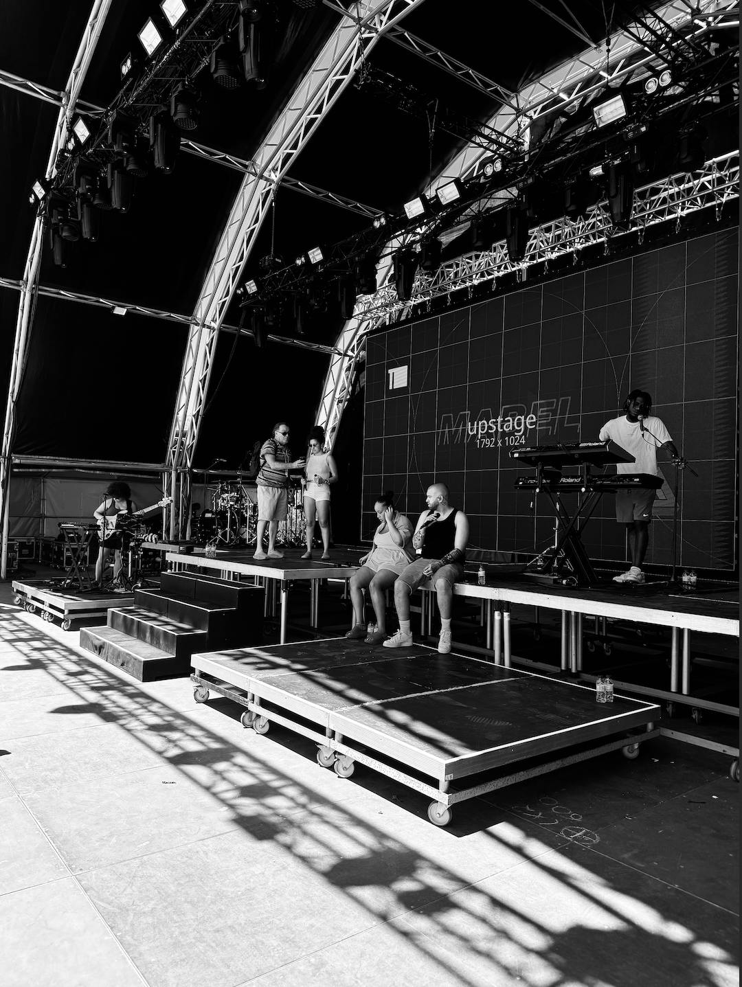 black and white image of a stage getting set up for a performance