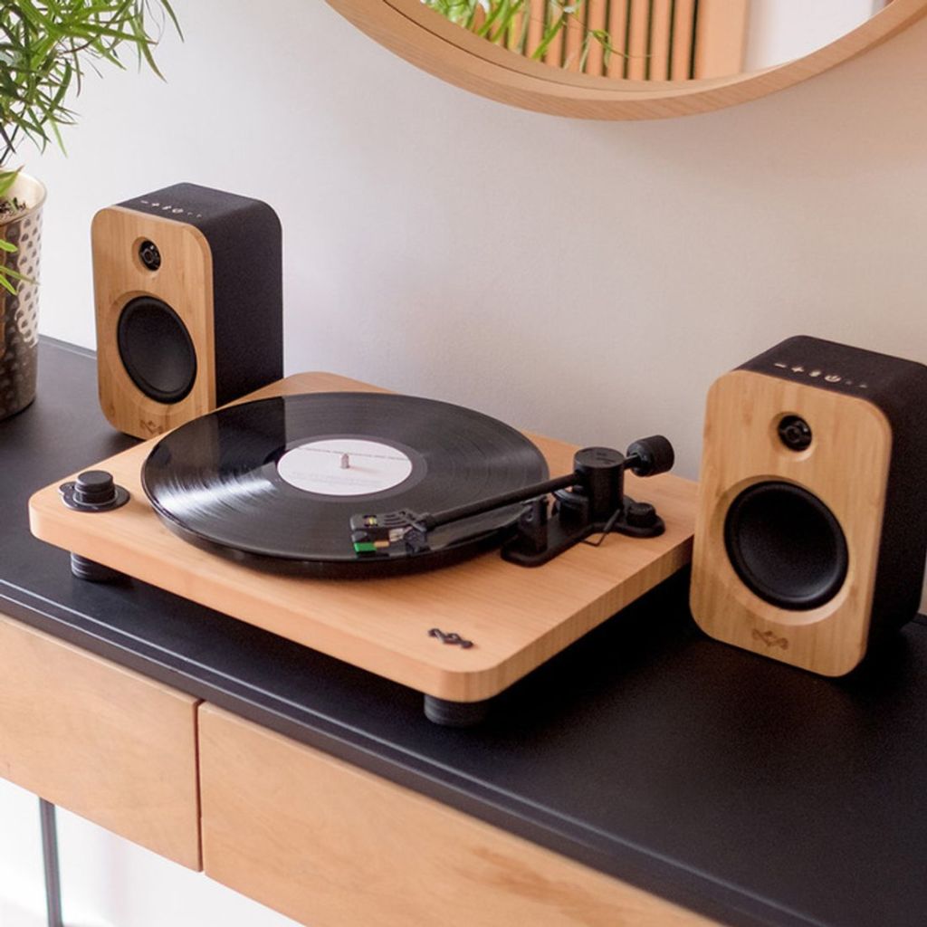 brown wooden turntable on top of accent table with speakers