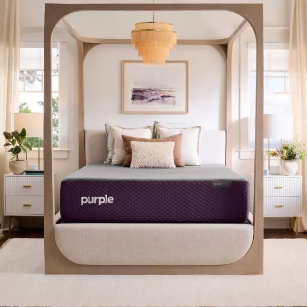 purple mattress on top of bed with pillows